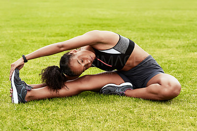 Buy stock photo Woman, athlete and stretching body on grass in preparation for running, exercise or workout. Active or fit female person in warm up leg stretch for fitness, sports training or cardio run on the field