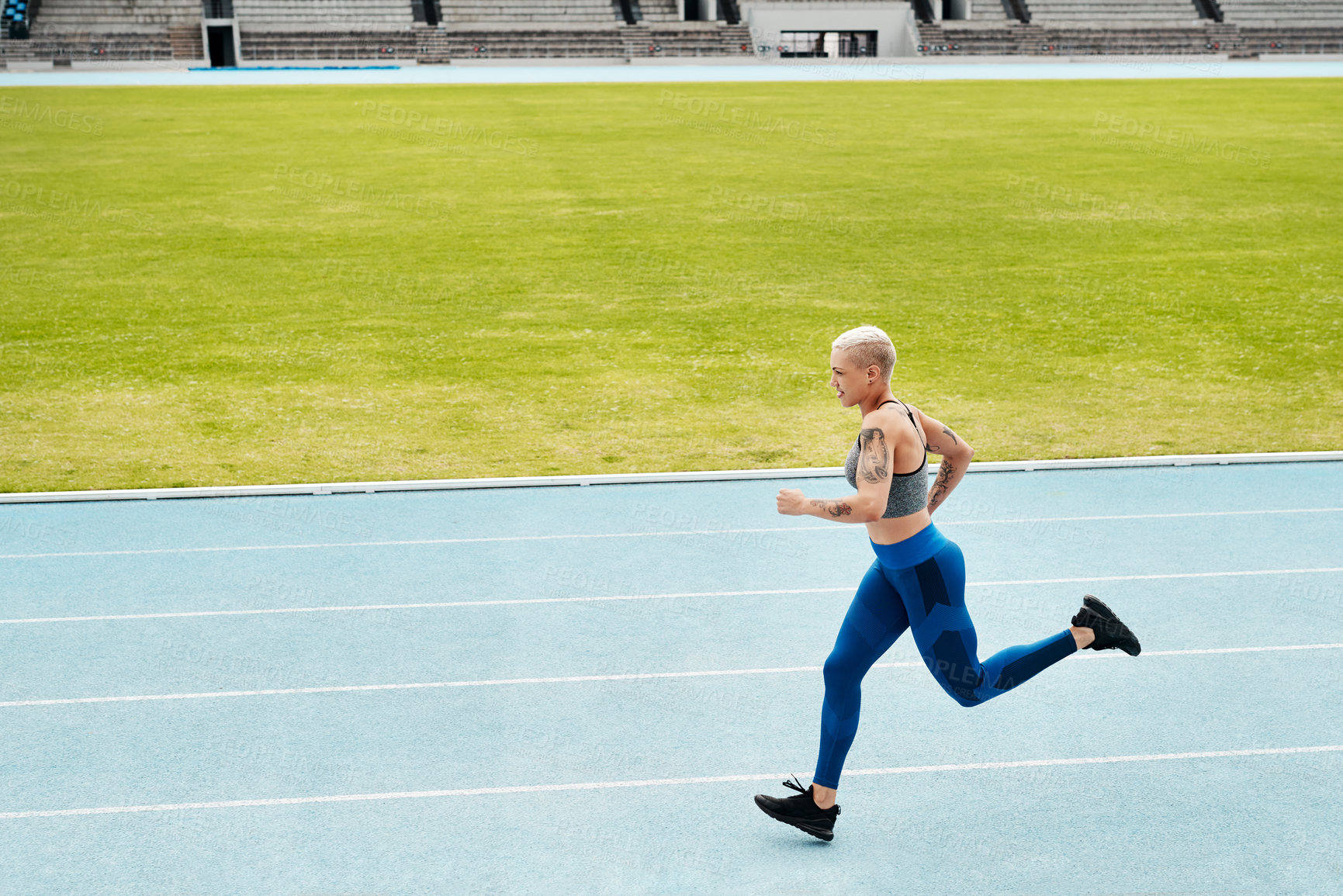 Buy stock photo Woman, stadium and athlete running on track for exercise, cardio training or workout outdoors. Fit, active or sporty female person or runner in sports fitness, run or race for athletics or wellness