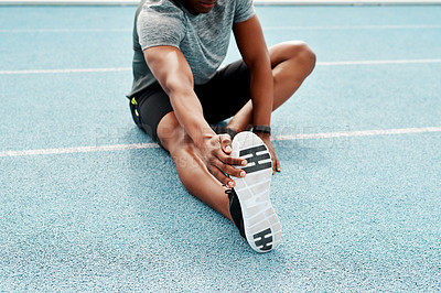 Buy stock photo Athlete, sitting and track for stretching legs to start training, exercise or running for fitness outdoor. Man, runner and warm up for muscle, body and wellness at stadium for race, contest or sports