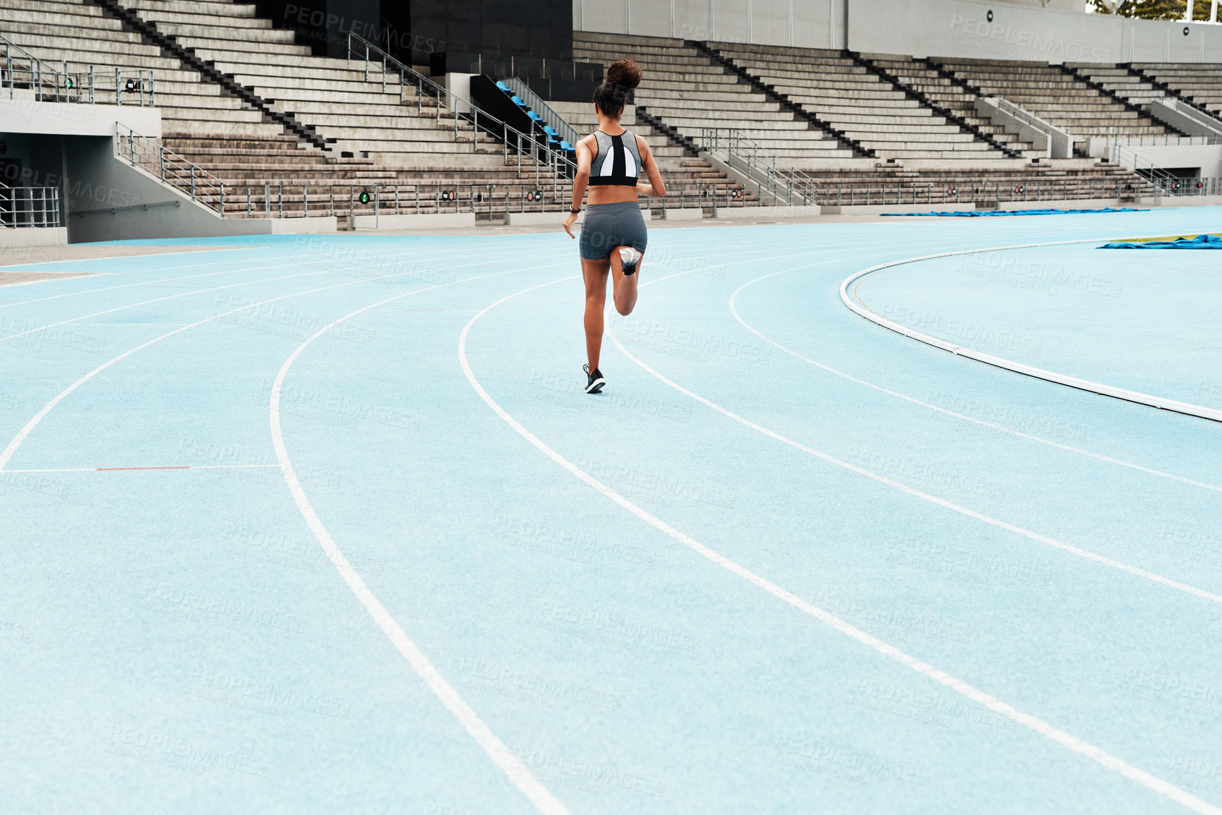 Buy stock photo Woman, back or athlete running on track for exercise, cardio training or outdoor workout to practice. Speed, go or fast girl runner in sports race, performance or athletics for wellness on stadium