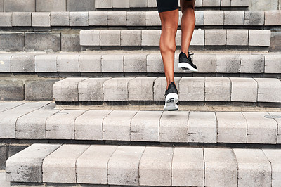 Buy stock photo Rearview shot of an unrecognizable athlete running up a flight of stairs alone during an outdoor workout session