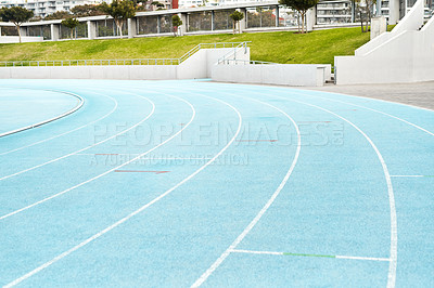 Buy stock photo Cropped shot of an empty athletic track field in a stadium during the day