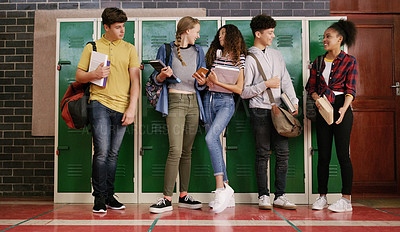 Buy stock photo Cropped shot of a group of cheerful young school kids talking to each other before class inside of a school during the day