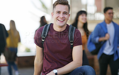 Buy stock photo Portrait of a cheerful young student standing by himself while waiting to go to class outside of a school during the day
