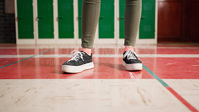 Buy stock photo Low angle shot of an unrecognizable student's shoes with the student standing and waiting to go to class inside of a school