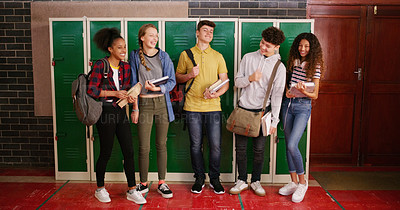 Buy stock photo Cropped shot of a group of cheerful young school kids talking to each other before class inside of a school during the day