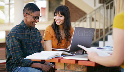 Buy stock photo Cropped shot of two young students working on a laptop together while waiting for class outside of a school