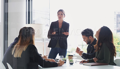 Buy stock photo Shot of a young businesswoman giving a presentation to her colleagues in an office