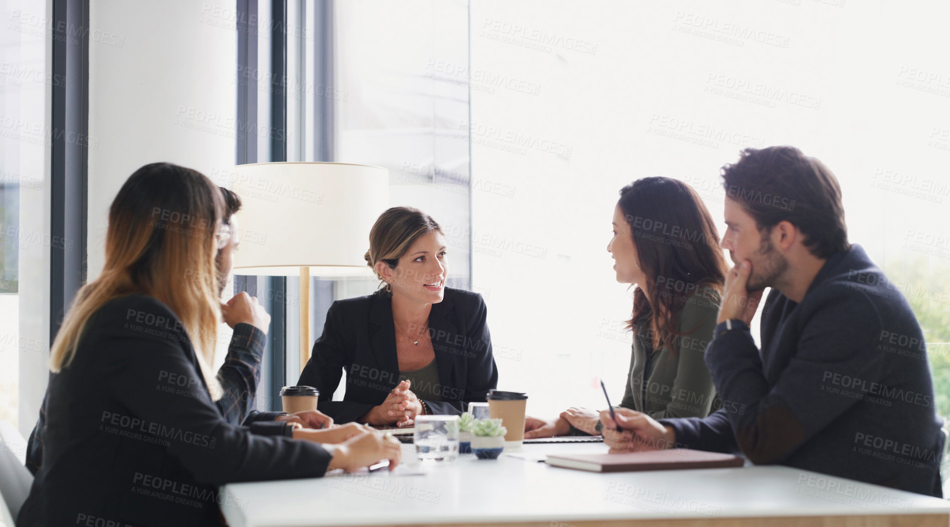 Buy stock photo Shot of a group of businesspeople having a meeting in a boardroom