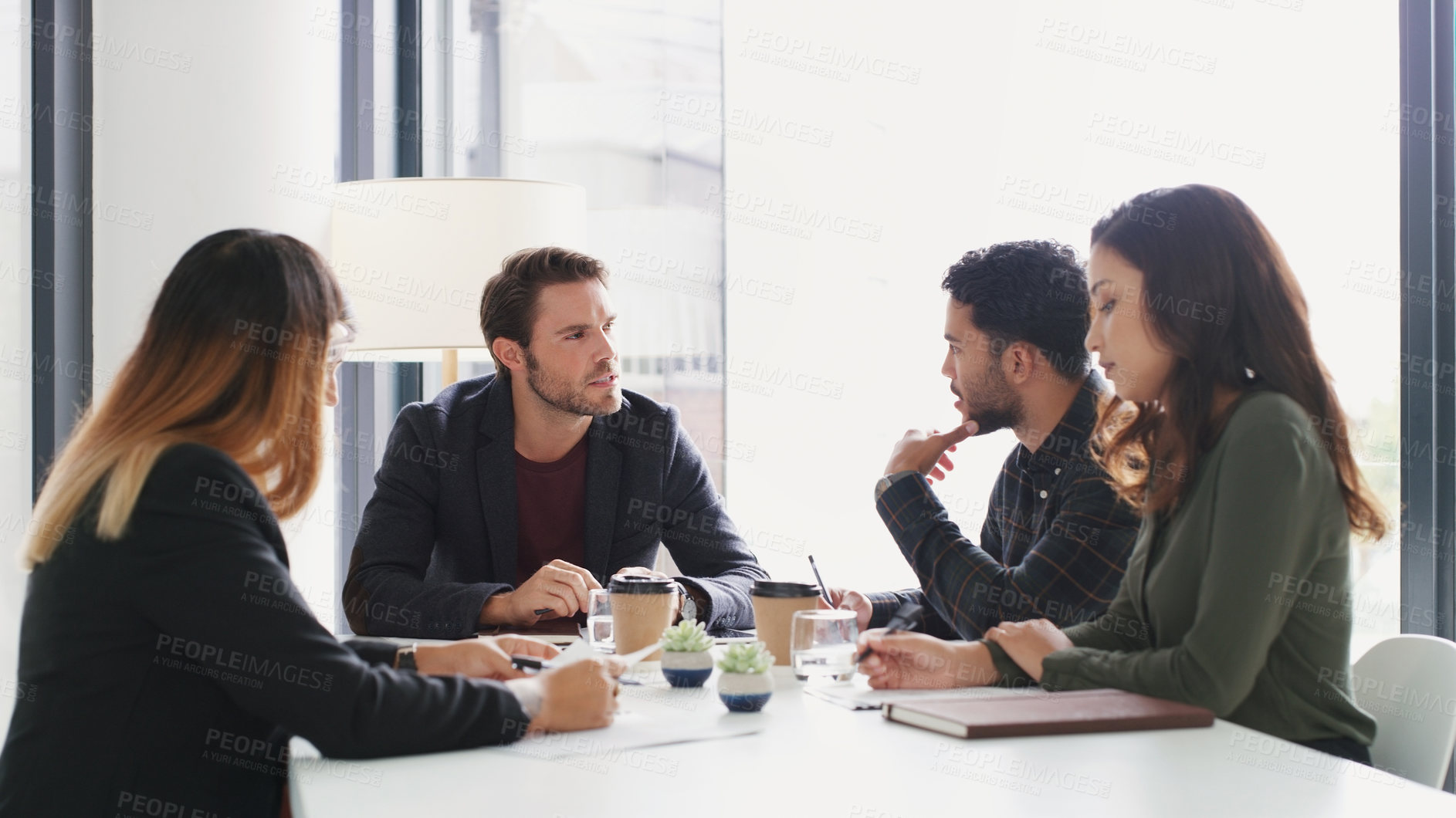 Buy stock photo Shot of a group of businesspeople having a meeting in a boardroom