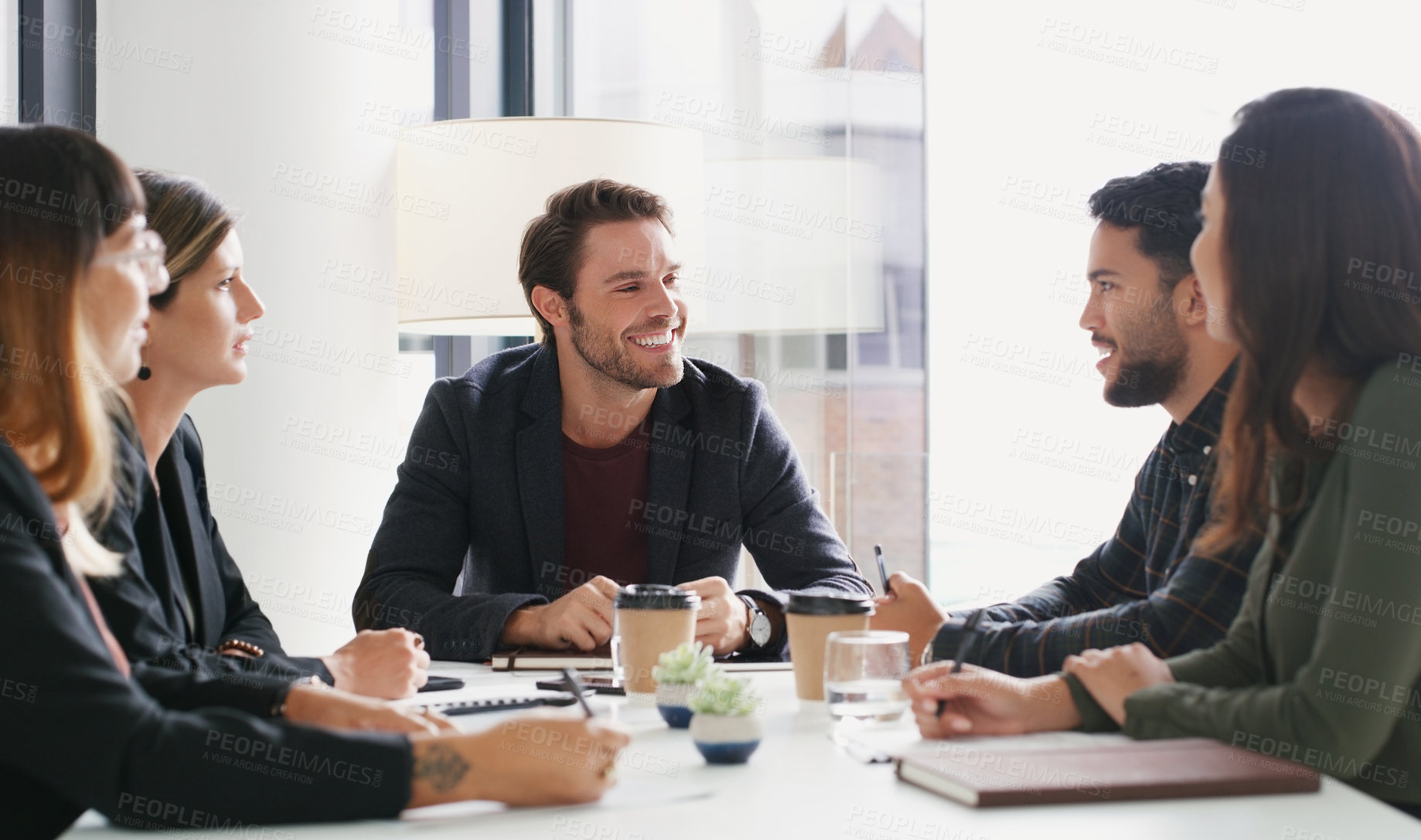 Buy stock photo Shot of a group of businesspeople having a meeting in a boardroom