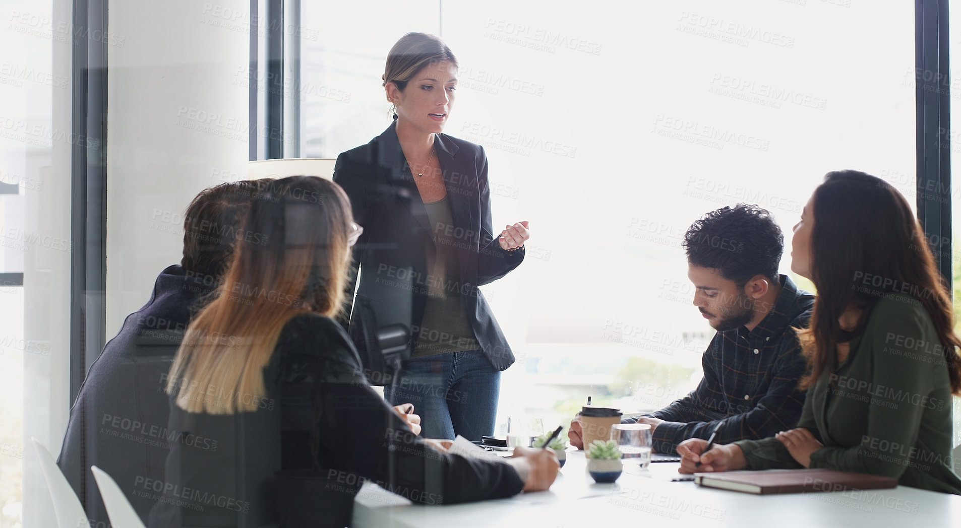 Buy stock photo Shot of a young businesswoman giving a presentation to her colleagues in an office