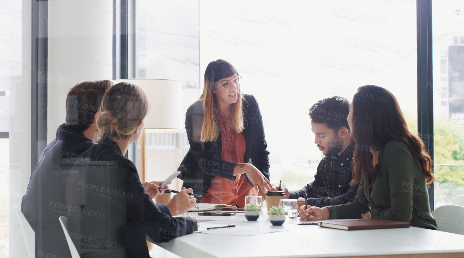 Buy stock photo Shot of a young businesswoman giving a presentation to her colleagues in an office