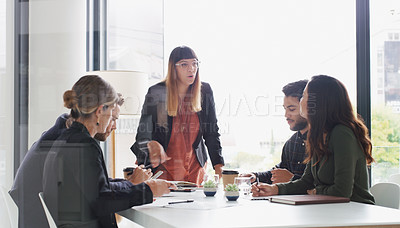 Buy stock photo Shot of a young businesswoman giving a presentation to her colleagues in an office