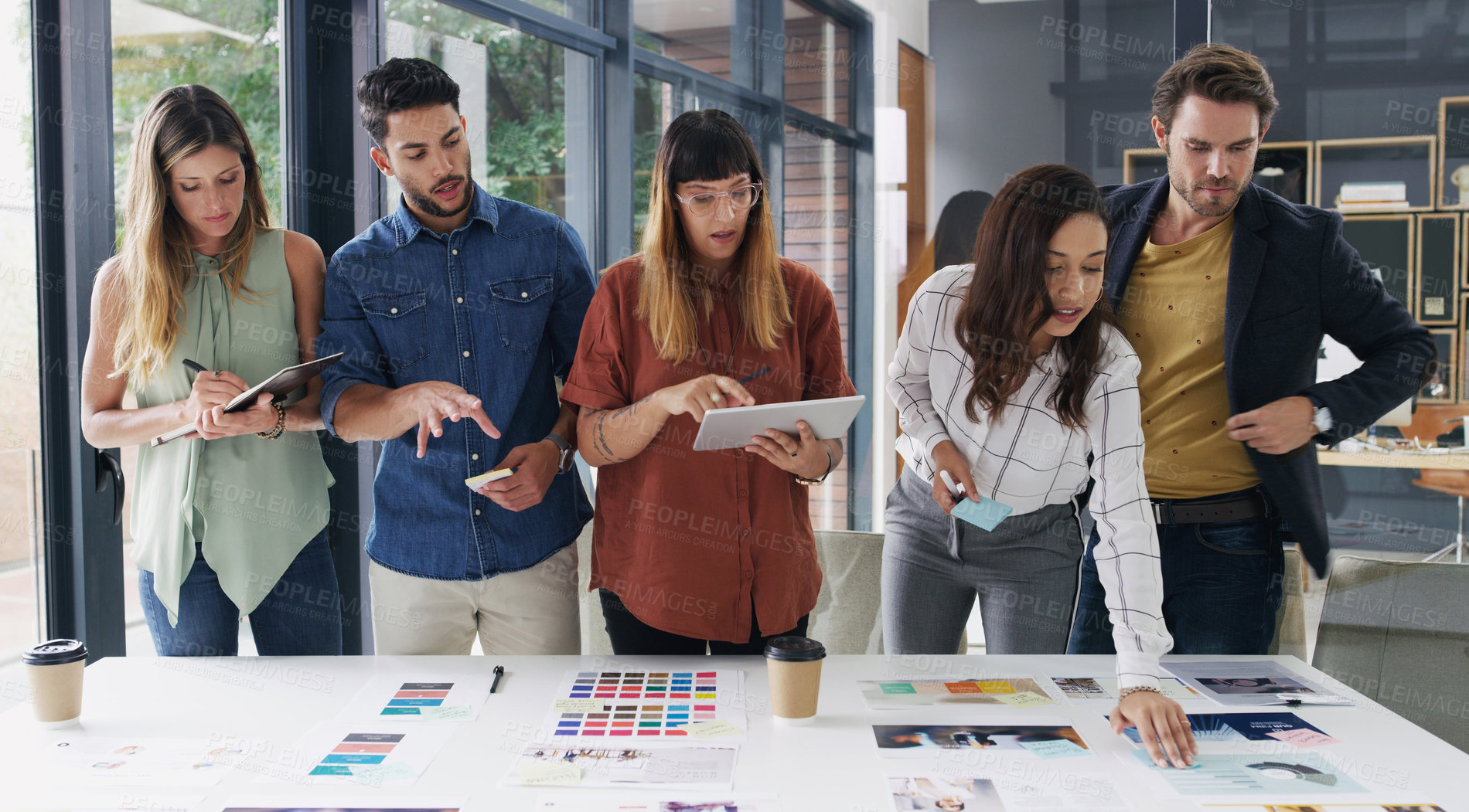 Buy stock photo Shot of a group of designers brainstorming together in an office