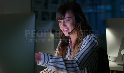 Buy stock photo Cropped shot of an attractive young businesswoman sitting in her office and wearing a headset while working on her computer