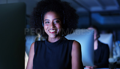 Buy stock photo Cropped portrait of an attractive young businesswoman wearing a headset and sitting in the office late at night