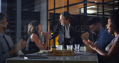 Buy stock photo Cropped shot of a diverse group of businesspeople celebrating after a successful meeting in the office late at night