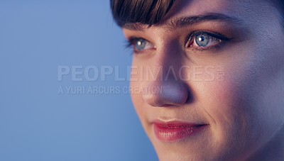 Buy stock photo Cropped shot of an attractive young woman looking away and standing alone against a studio background