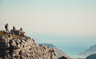 Buy stock photo Shot of a group of friends hiking up a mountain