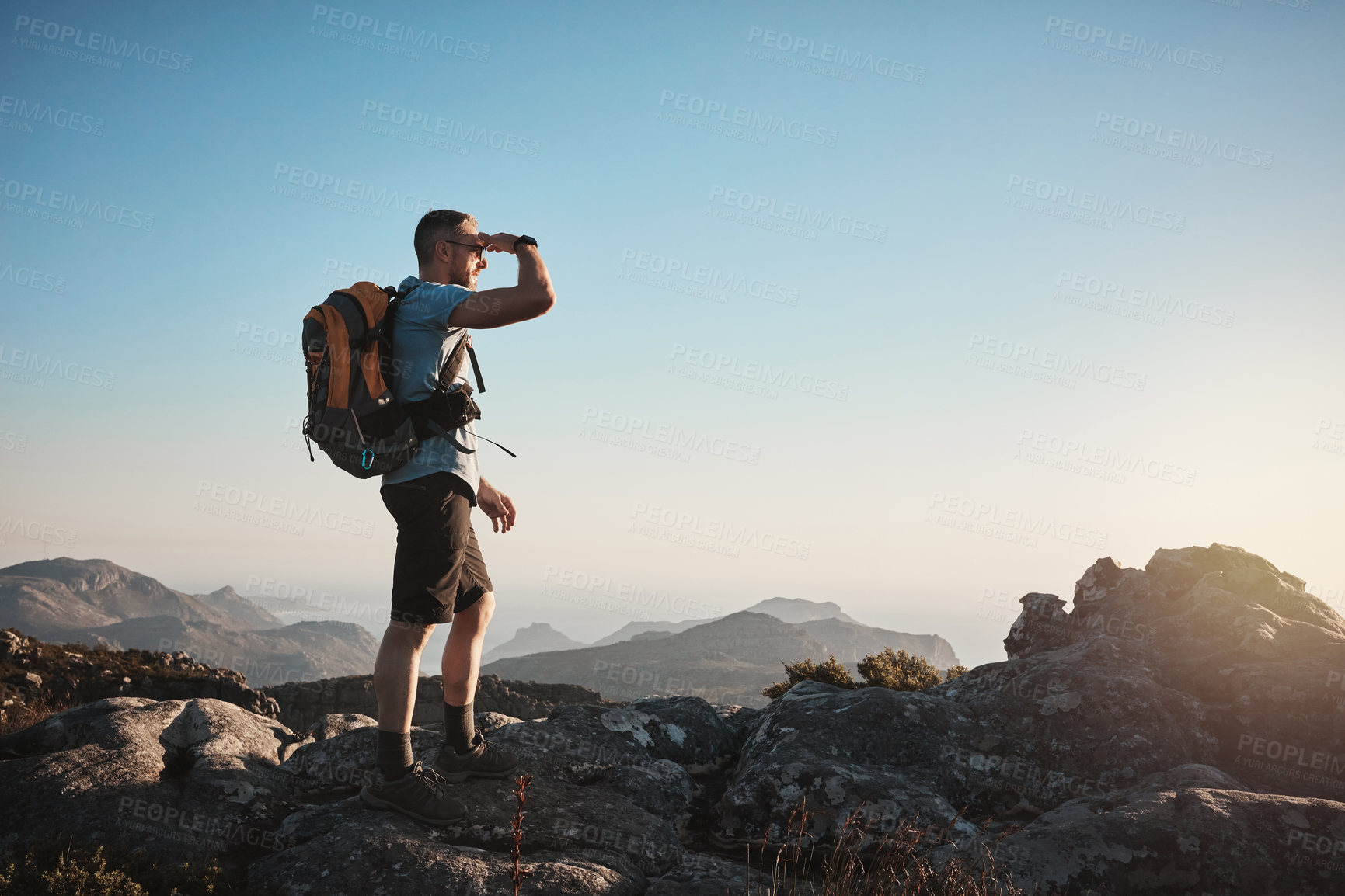 Buy stock photo Shot of a mature man hiking up a mountain
