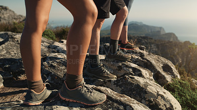 Buy stock photo Cropped shot of a group of friends hiking up a mountain