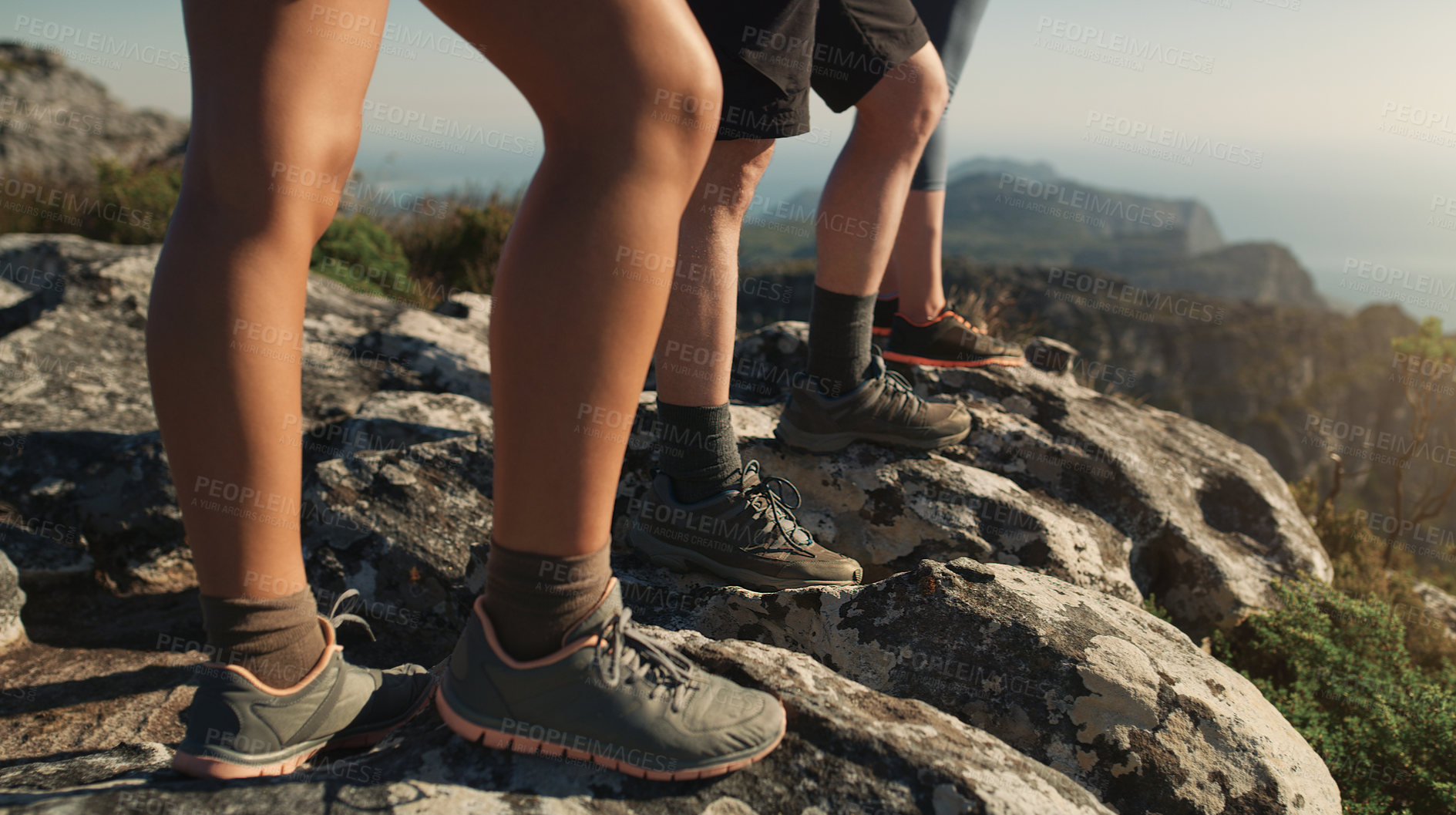 Buy stock photo Cropped shot of a group of friends hiking up a mountain