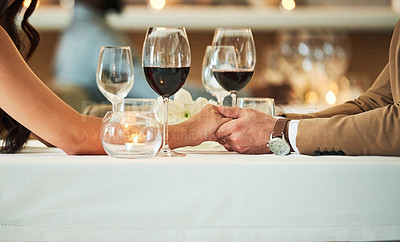 Buy stock photo Love, wine and couple holding hands in restaurant for romantic dinner, date and anniversary celebration. Relationship, fine dining and man and woman together for luxury date, alcohol and honeymoon