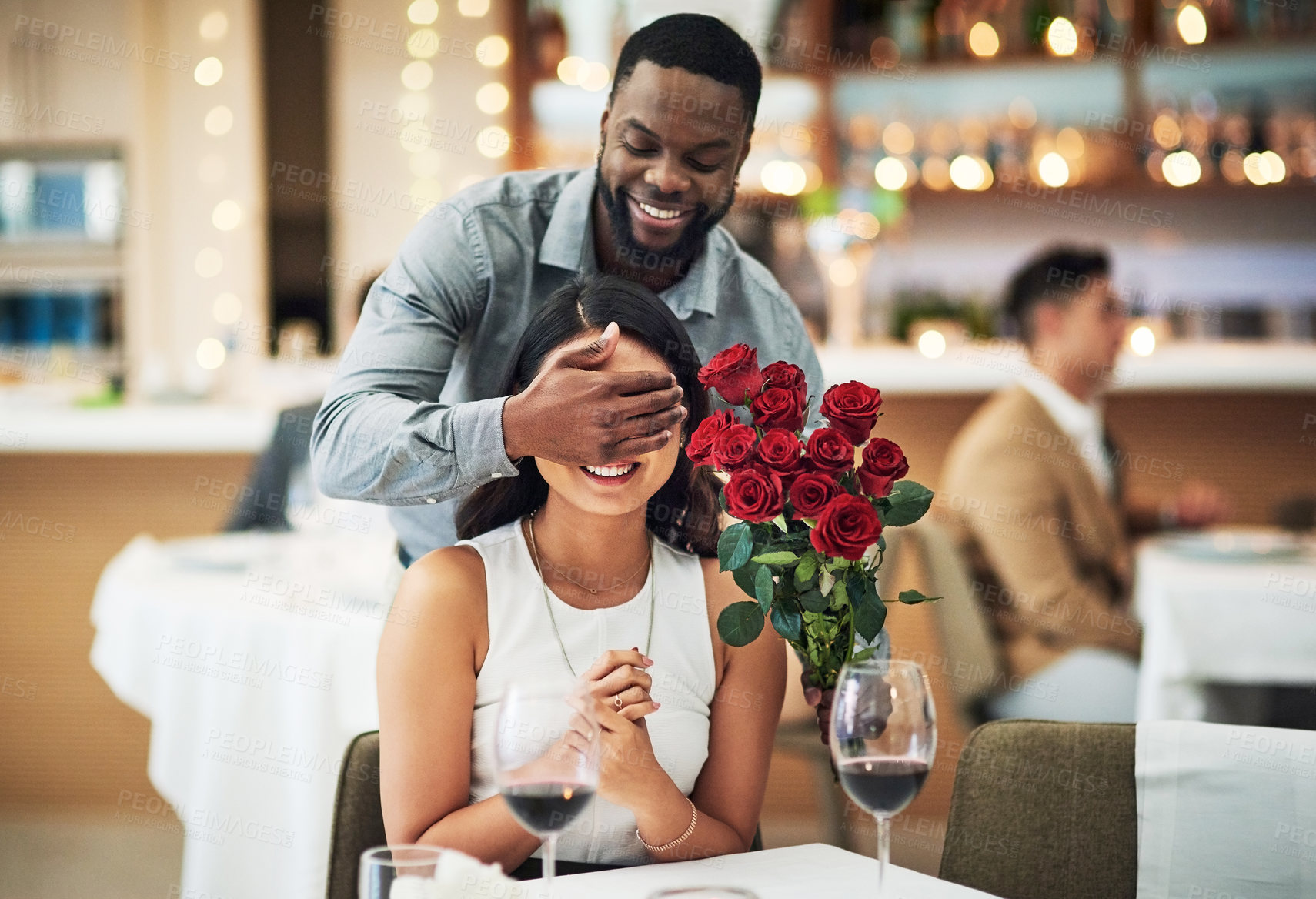 Buy stock photo Rose surprise, couple and restaurant of people ready for fine dining with love and care. Flowers present, bouquet and date of a woman and man together with celebration on a table with a smile