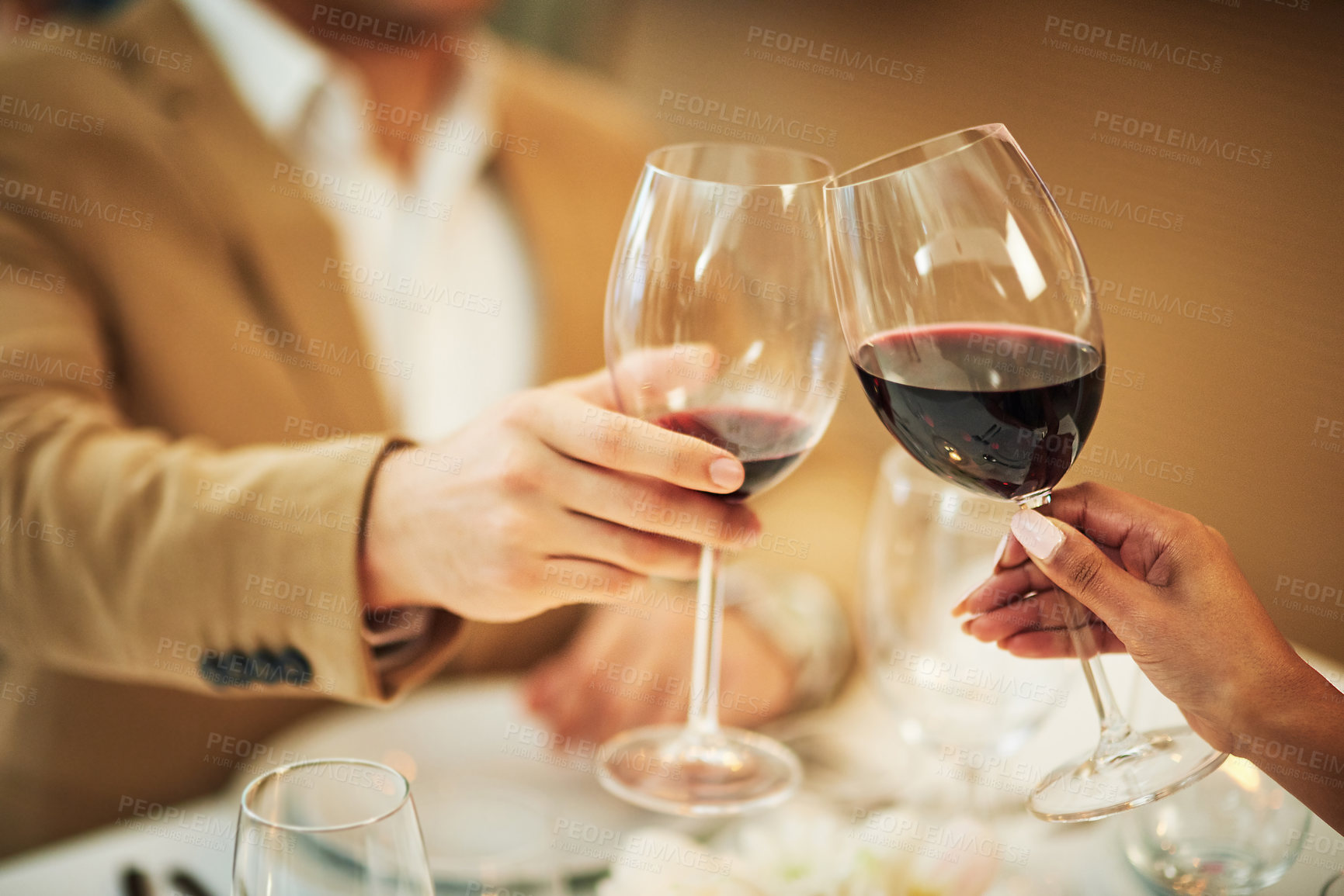 Buy stock photo Toast, wine and hands of couple in restaurant for romantic dinner, date and anniversary celebration. Relationship, fine dining and man and woman cheers together for social drinks, alcohol and relax