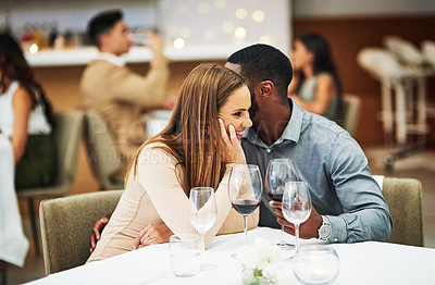 Buy stock photo Love, man whisper with woman and in restaurant with wine glasses, happiness or cheerful on Valentines day. Romance, couple or flirty for quality time, romantic or conversation with fine dining or joy
