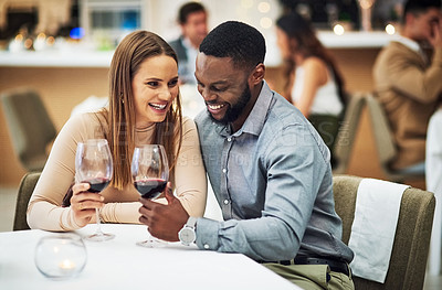 Buy stock photo Cheers, love and couple on a date in a restaurant for valentines day, romantic event or anniversary. Happy, smile and interracial man and woman drinking wine, talking and bonding at a luxury dinner.