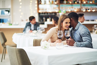 Buy stock photo Restaurant date, couple and wine celebration of a man telling a secret at a dinner table. Anniversary celebration, valentines day smile and wine at night with love, care and conversation together 