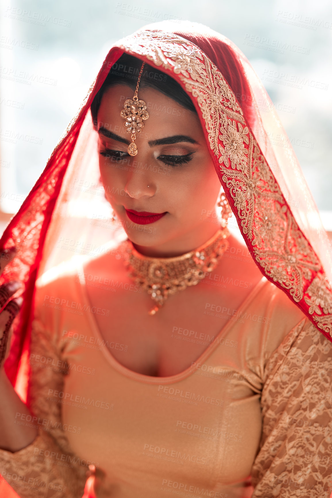 Buy stock photo Indian woman, thinking and wedding fashion by window with red saree, gold jewelry or makeup for beauty. Marriage ceremony, accessories or bride with culture for celebration, commit or hindu custom