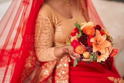 Buy stock photo Hindu, wedding and woman with floral bouquet in hand for traditional, clothes and marriage. Bride, elegant dress and henna with bunch of flowers on bed for Mehendi ceremony, decoration and accessory