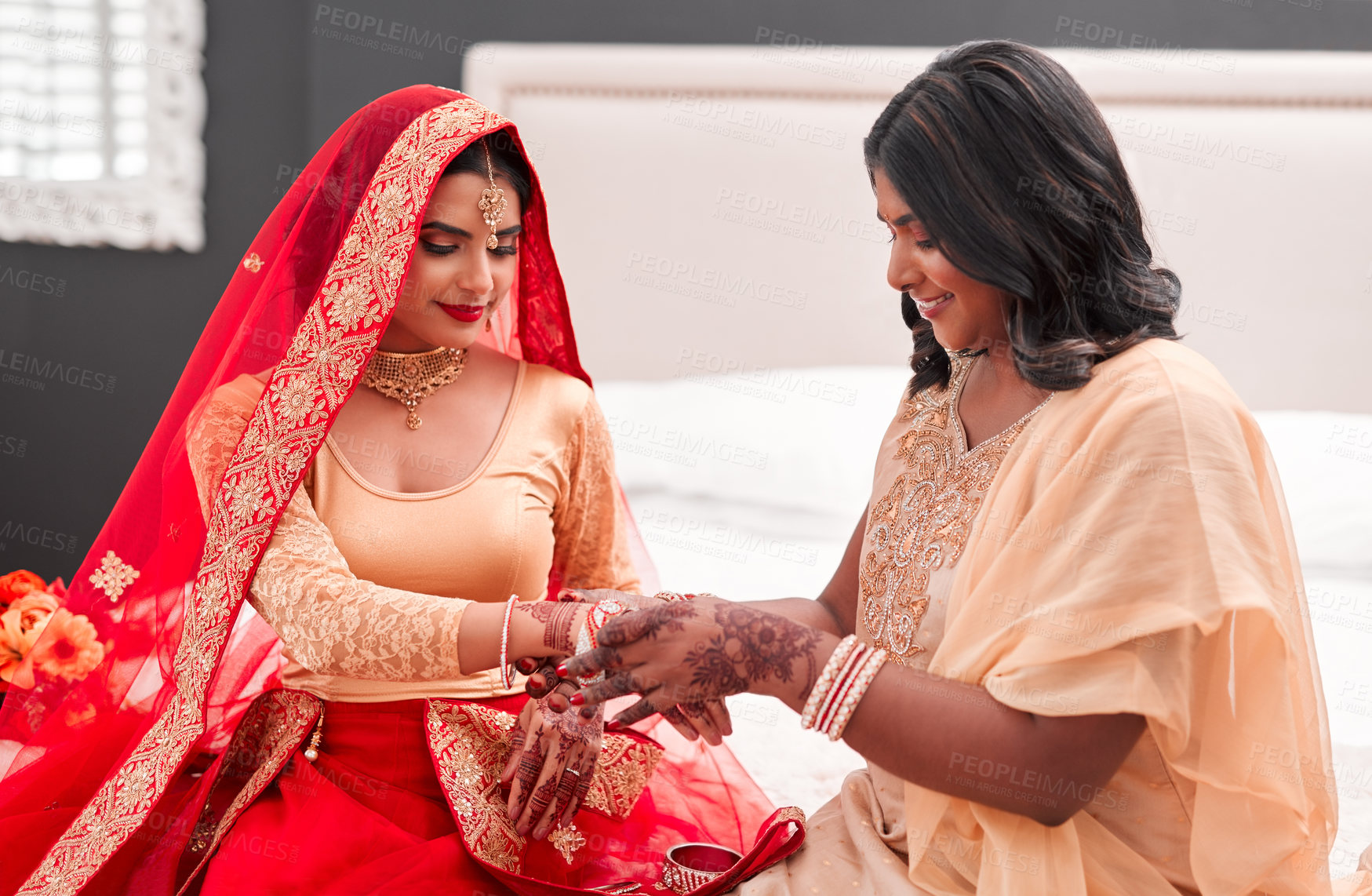 Buy stock photo Indian bride, bridesmaid and bracelets for wedding, celebration and love for marriage. Woman, henna and culture with traditional mehendi, sari and hindu bridal jewelry with support and help dressing