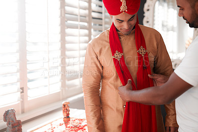 Buy stock photo Indian, wedding and groom with culture, ready and help from tailor in ceremony, fitting and bedroom. Turban, traditional and man with smile for clothes, attire and marriage of person in Mumbai