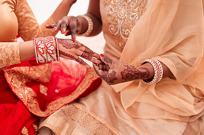 Buy stock photo Cropped shot of an unrecognizable woman getting her bracelets put on by her bridesmaid on her wedding day
