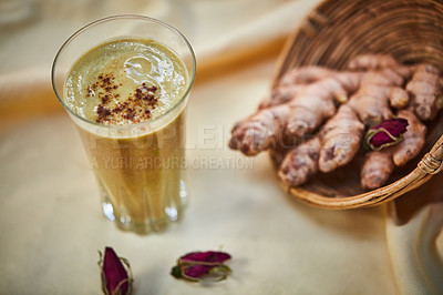 Buy stock photo Shot of a freshly made ginger smoothie on a table