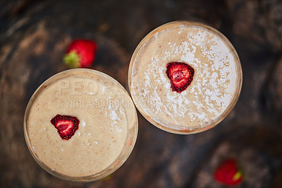 Buy stock photo Shot of a freshly made cream snack served in a glass with strawberries on a table