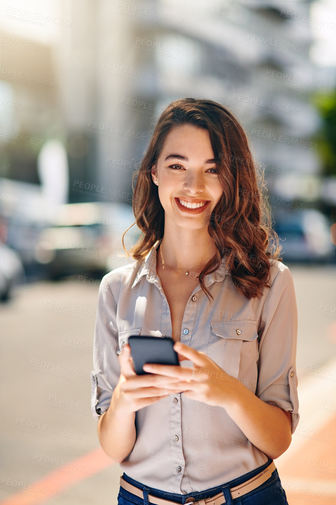 Buy stock photo Cropped portrait of an attractive young businesswoman sending text messages during her morning commute to work