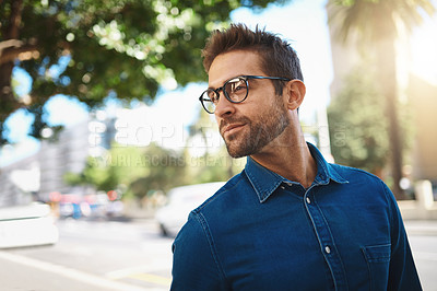 Buy stock photo Closeup shot of a handsome middle-aged man spending the day out in the city