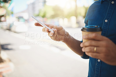 Buy stock photo Cropped shot of an unrecognizable man using his cellphone while out in the city