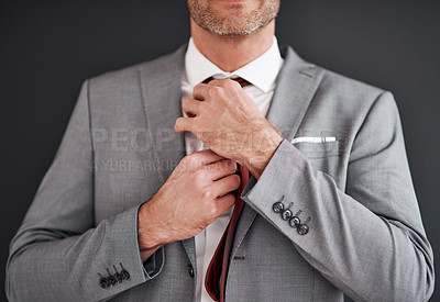 Buy stock photo Cropped shot of an unrecognizable middle aged bridegroom adjusting his necktie in preparation for his wedding