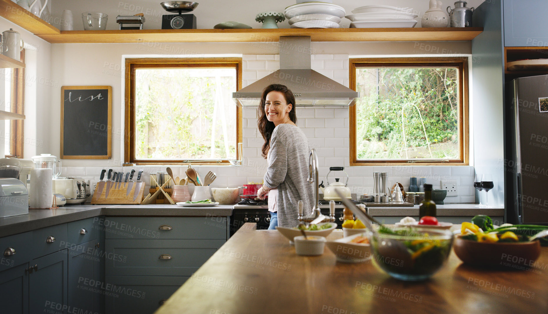 Buy stock photo Woman, cooking and happy with portrait in kitchen for pasta, organic ingredients and confidence in home. Person, food and meal prep at stove with spaghetti, recipe or smile at apartment in Italy