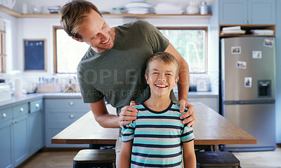 Buy stock photo Cropped shot of an affectionate young father looking at his son while standing in their kitchen at home