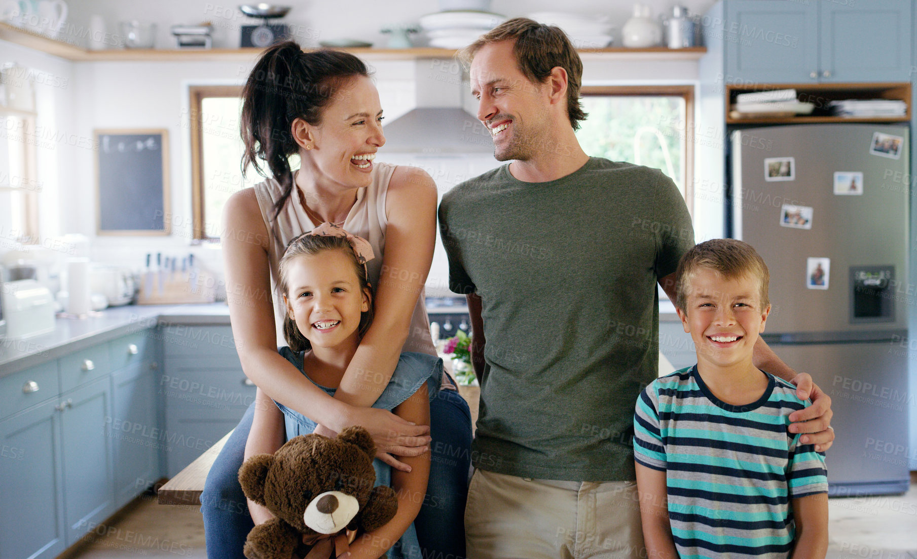 Buy stock photo Laugh, hug and parents with children in kitchen with embrace for bonding, relationship and love in home. Happy, house and portrait of mom, dad and kids for funny joke, affection and fun for weekend