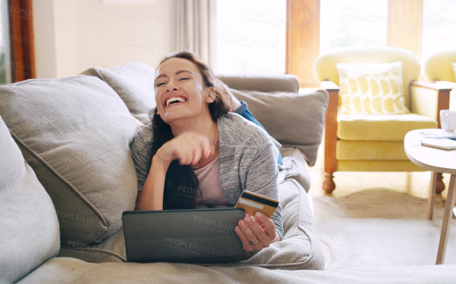 Buy stock photo Woman, home and laughing on tablet with debit card on sofa for online shopping, payment and saving plan. Rewards, living room and happy on couch for internet banking, budget and investment or finance