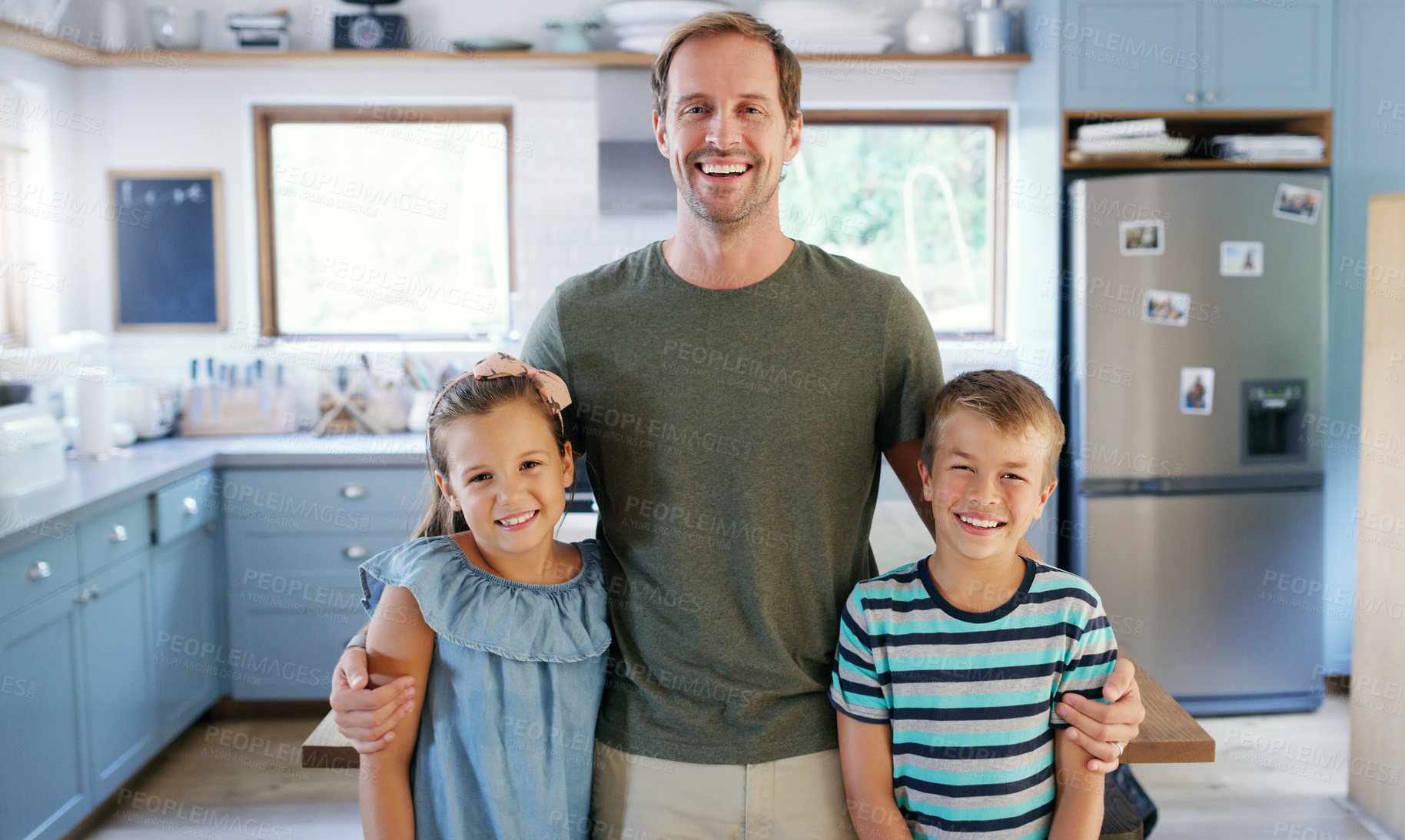 Buy stock photo Cropped portrait of an affectionate young father standing with his two kids in the kitchen at home
