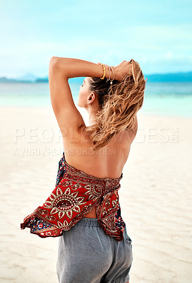 Buy stock photo Shot of a beautiful young woman spending time at the beach on a sunny day
